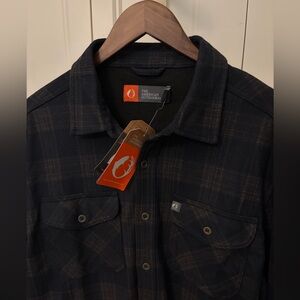 The American Outdoorsman’s Men’s flannel button down shirt. Dark Navy & Brown